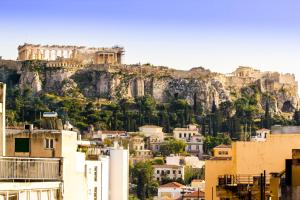 a view of the acropolis of athens from a city at Feel Athens Studios at Monastiraki in Athens