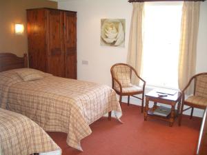 
A bed or beds in a room at Whoop Hall Hotel and Leisure
