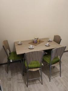 a table with four chairs and a wooden table and chairsuggest at Hostel Ginger House in Plovdiv +34 photos