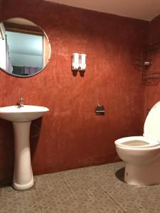 a bathroom with a toilet and a sink and a mirror at สวนฉัน Igarden in Ban Pang Champi