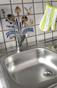 a kitchen sink with a faucet on top of it at Apartmenthaus Duderstadt in Duderstadt