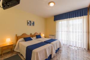 Säng eller sängar i ett rum på Hotel La Bolera