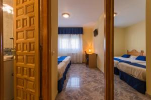 Posteľ alebo postele v izbe v ubytovaní Hotel La Bolera