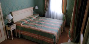 Postel nebo postele na pokoji v ubytování Hotel Villa Delle Palme