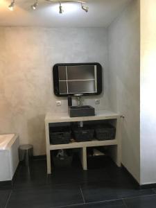 a television sitting on a shelf in a room at Maison de village in Velleron +15 photos