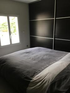 a bedroom with a large bed and a window at Maison de village in Velleron