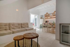 a living room with a couch and two stools at qui no passa in Ciutadella +44 photos