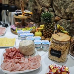 a table topped with different types of food on it at Macchie e Fiori in Pianottoli-Caldarello