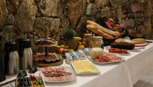 a table with many different types of food on it at Macchie e Fiori in Pianottoli-Caldarello