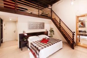 a bedroom with a large bed and a staircase at Hotel De Petris in Rome