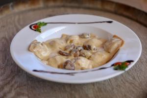 a bowl of mushrooms and gravy on a white plate at Macchie e Fiori in Pianottoli-Caldarello