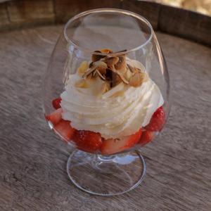 a glass cup with whipped cream and strawberries and nuts at Macchie e Fiori in Pianottoli-Caldarello