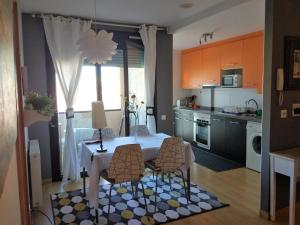 a kitchen with a table and chairs in a kitchen at Sueve 5 in Colunga