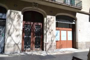 バルセロナにあるEnjoy Apartments Borrellのバルコニー付きの建物のドア