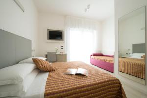 Postel nebo postele na pokoji v ubytování Hotel Pillon