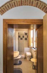 a bathroom with two toilets and a sink at Helvetia Pisa Tower in Pisa