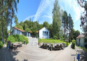 a wooden deck with benches and a building at SeminarZentrum Rückersbach in Johannesberg