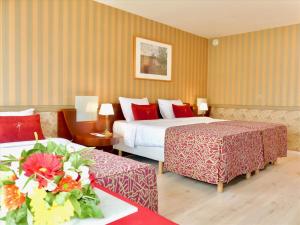 Postel nebo postele na pokoji v ubytování Golden Tulip Hotel de’ Medici