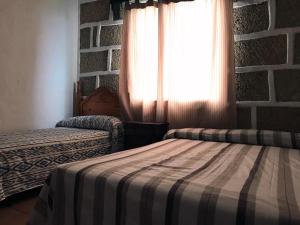 Un pat sau paturi într-o cameră la Casa Maria Luisa