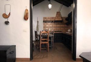 a kitchen with a table and chairs in a room at Casa Maria Luisa in San Miguel de Abona