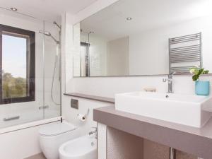 ein Badezimmer mit Waschbecken, Toilette und Spiegel in der Unterkunft Villa Can Paulo in Santanyi + 23 Fotos