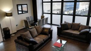 a living room with two couches and a table at Access Tower Hill in London