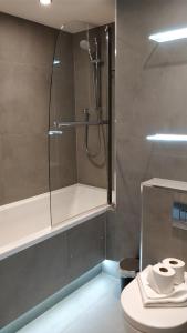 a bathroom with a shower and a toilet at Access Tower Hill in London