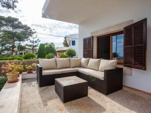 a living room with a couch and a table at Villa Estrella Sea View in Cala Figuera