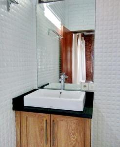 a bathroom with a sink and a mirror at APM Equestrian Resort in Tangerang