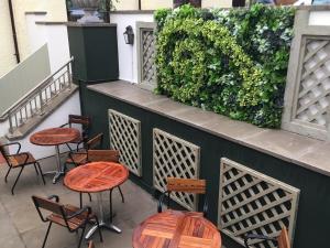 a group of tables and chairs on a patio at The Seaton Lane Inn - The Inn Collection Group in Seaham
