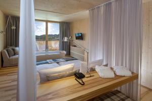 A bed or beds in a room at Tannenhof Sport & SPA