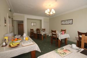 a dining room with a table with fruit on it at Inglestone House Guest House in Kelso