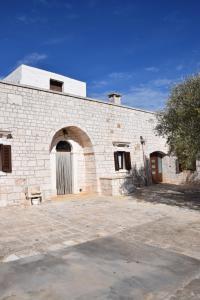 a large brick building with a door on it at Dimora Domrose in Locorotondo