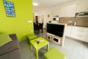 a living room with a couch and a tv and a table at Apartma Mariposa Banovci in Banovci