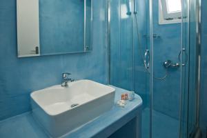 a bathroom with a sink and a shower at Corrado Caldera Apartments in Fira
