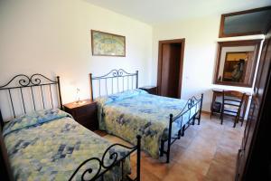 a bedroom with two beds and a mirror at Agriturismo San Fedele in Perugia