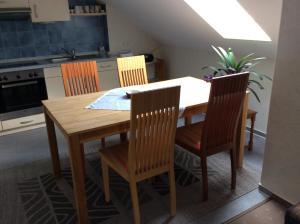 a kitchen with a wooden table and four chairs at Ferienwohnung Albers in Blomberg