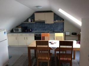 a kitchen with a table and chairs in a room at Ferienwohnung Albers in Blomberg