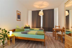 1 dormitorio con 2 camas, mesa y sillas en Ferienwohnung Hilbrecht en Arnstadt