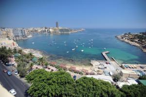 a view of a beach with boats in the water at Carlton Hotel in Sliema