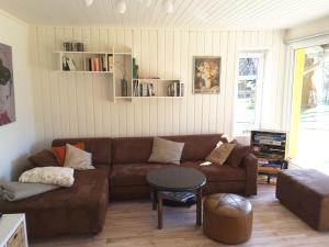 a living room with a brown couch and a table at Bleichehof in Burg