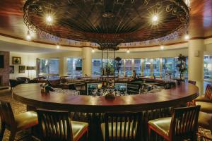 a bar in a restaurant with chairs and a table at Mövenpick Hotel & Residences Nairobi in Nairobi +171 photos