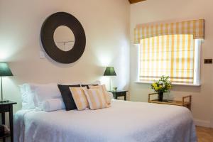 a bedroom with a bed with a mirror on the wall at Clare Valley Heritage Retreat in Clare