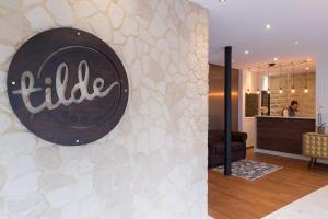 a lobby of a hotel with a sign on a wall at Hôtel Tilde in Paris