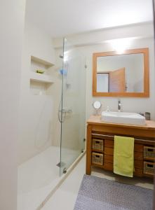 a bathroom with a shower and a sink and a mirror at Spacious Fully Equipped 3BD 2Bath Apt in the heart of city with Balconies AC and fast WIFI #2 in Heraklio Town