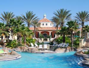 a resort with a swimming pool and palm trees at Regal Palms Resort & Spa in Davenport