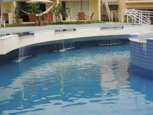 a swimming pool with water fountain in a building at Solar Água Pipa - Apto 115 in Pipa