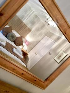a reflection of a bedroom in a mirror at Honeypot Cottage in Centre of Bowness in Bowness-on-Windermere