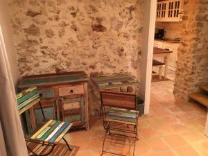 a kitchen with some chairs and a table and a counter at Le Champmazet in La Roquette-sur-Siagne