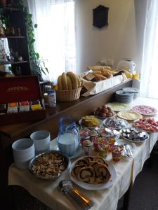 a table with many different types of food on it at Hotel Stella in Pilsen